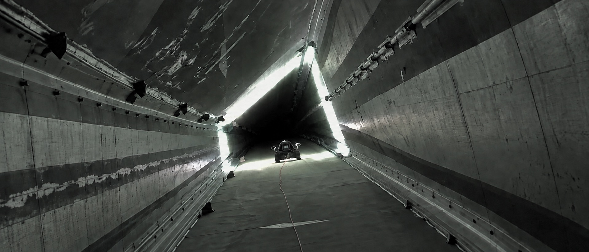 A Detectra crawler deep inside a wind turbine blade, lit from behind by its own lamps.